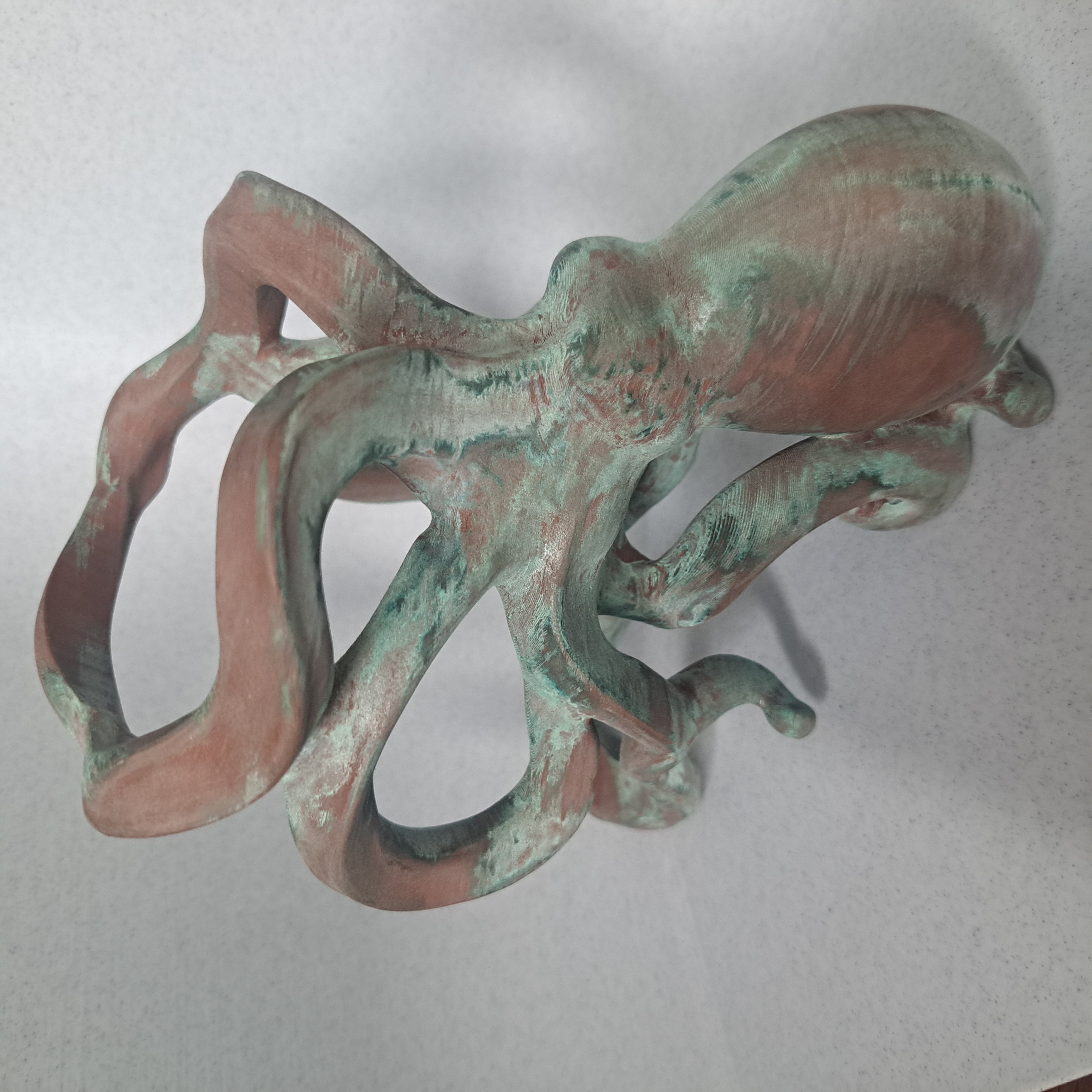 Octopus holder patina study showing verdigris concentration