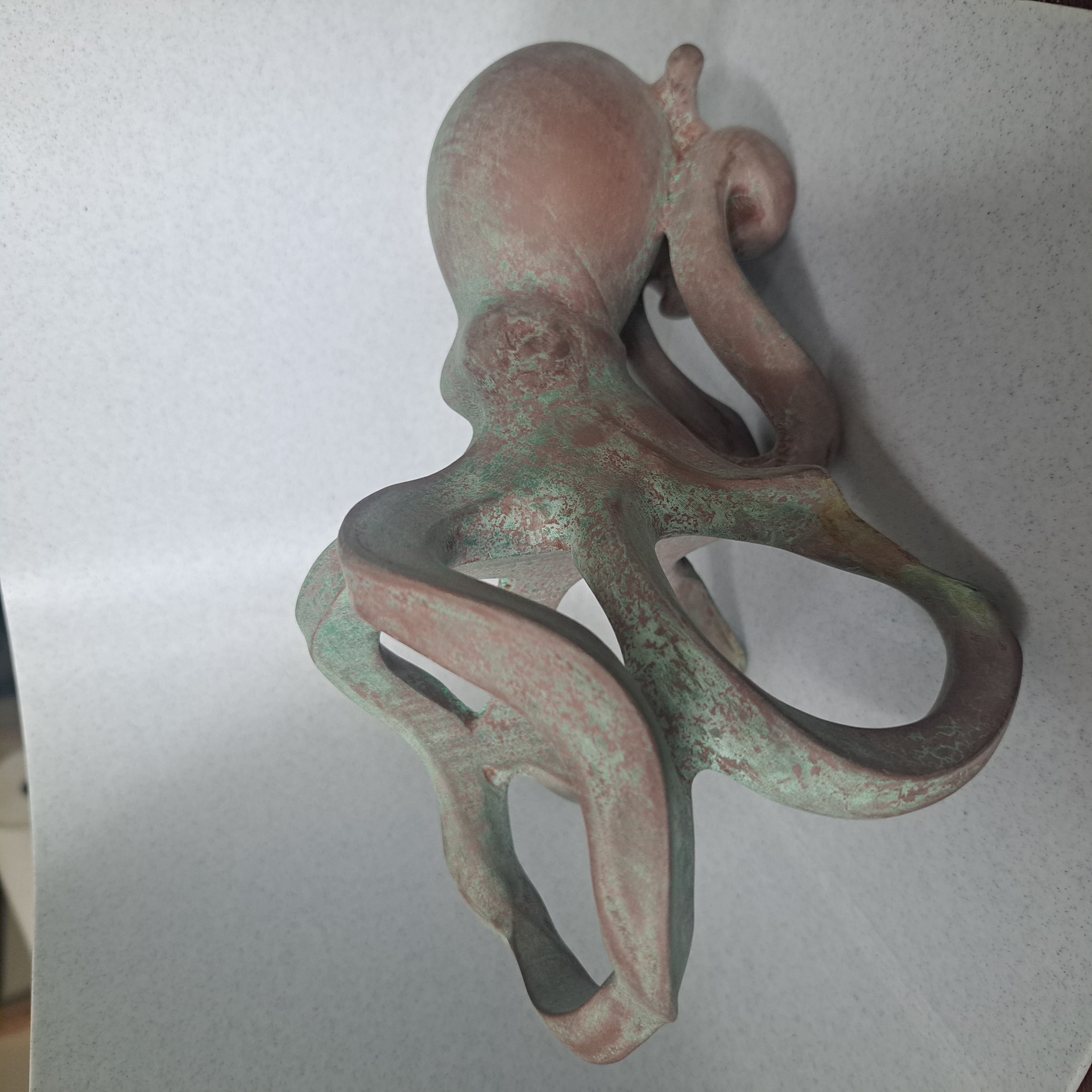 Three-quarter view of patinated octopus holder